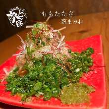 Seared thighs covered in green onions